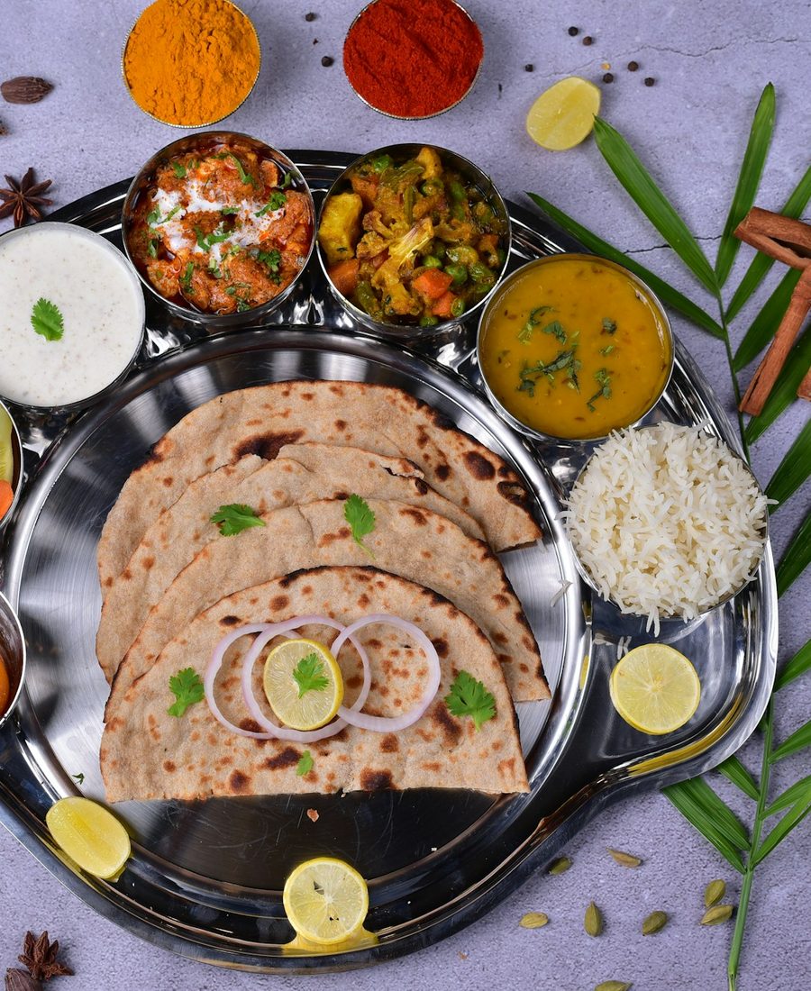 A homestyle veg thali with rotis, mixed vegetable sabzi, dal, pickle and chaas